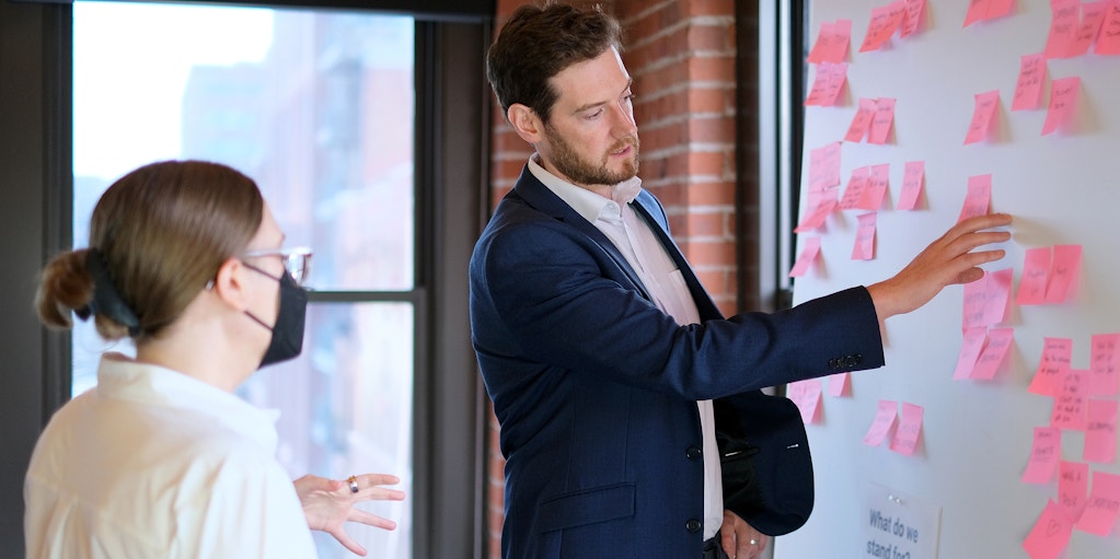 Charlie Paterson engaged in a brainstorming session with a colleague