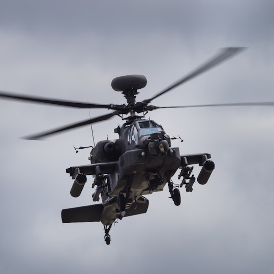 Military helicopter flying through the air