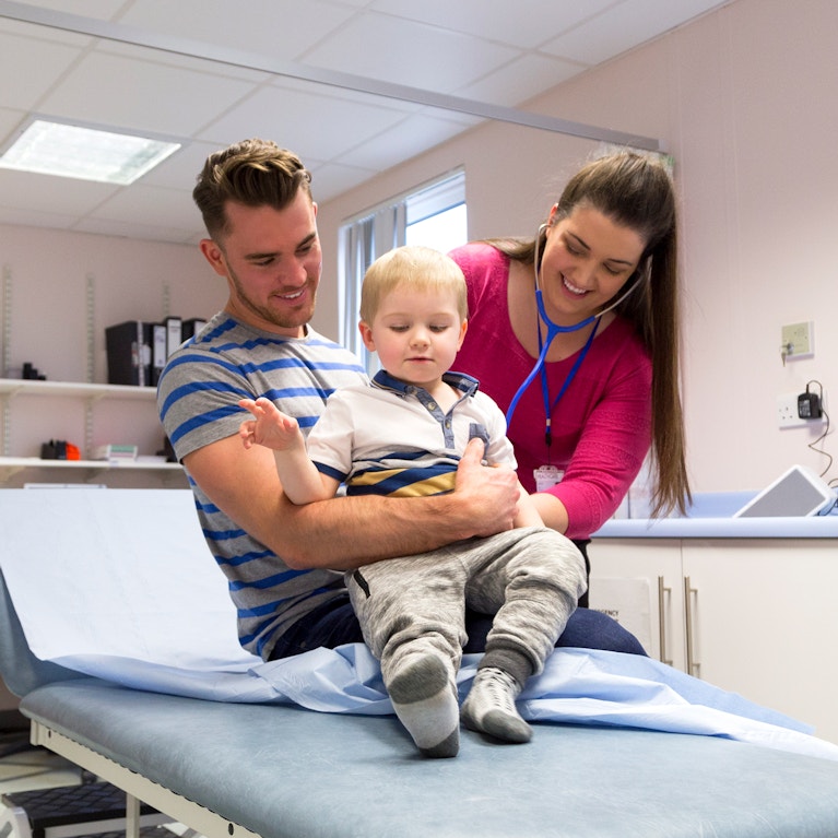 Female doctor examines child
