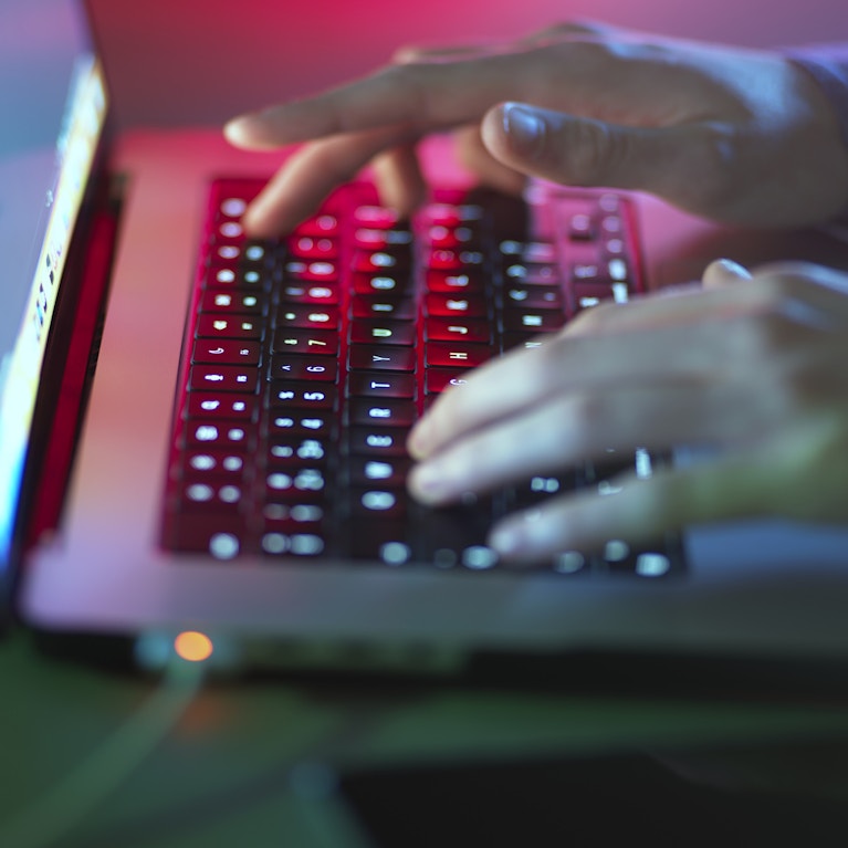Laptop with a person's hands on the keyboard.