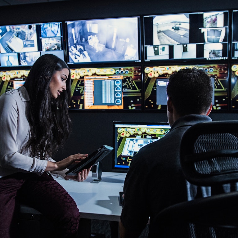 Security guards watching monitors in control room