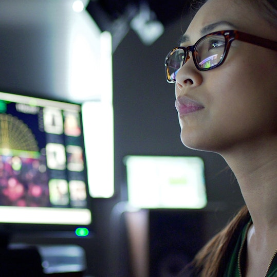 Woman reviewing data on screens