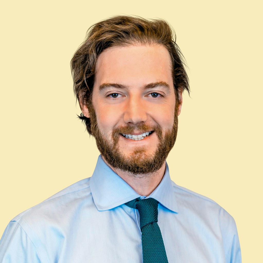 Portrait of Charlie Paterson on pale yellow background