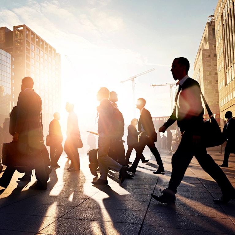 Business people walking down a sunny street