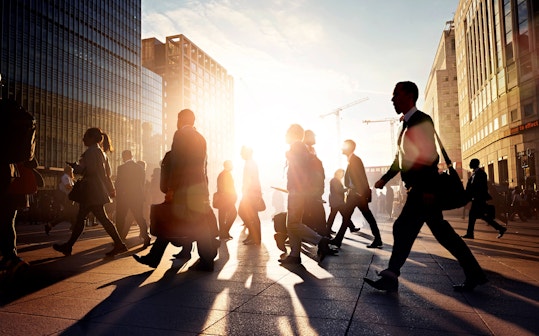 Business people walking down a sunny street