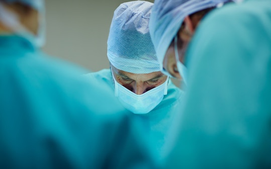 Surgeons working in operating room