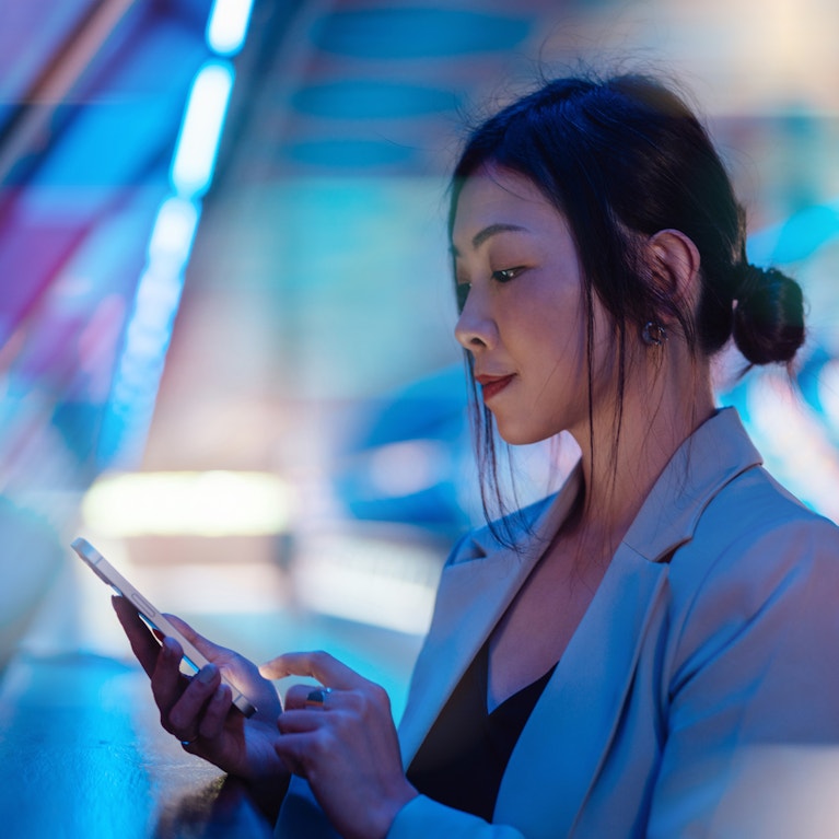 A woman looking at a tablet.