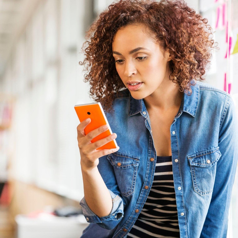 Woman reading information on her mobile phone