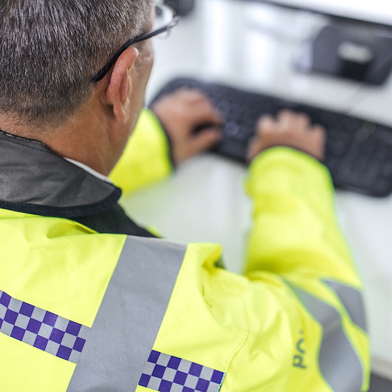 British police officer writing a report