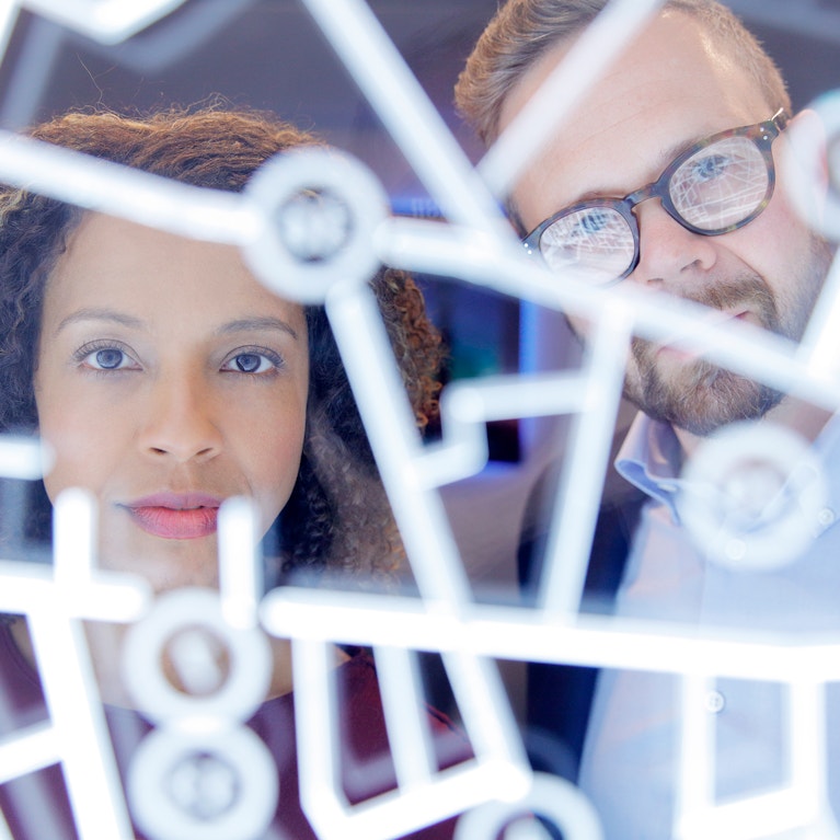 Business people looking through a futuristic digitally generated display