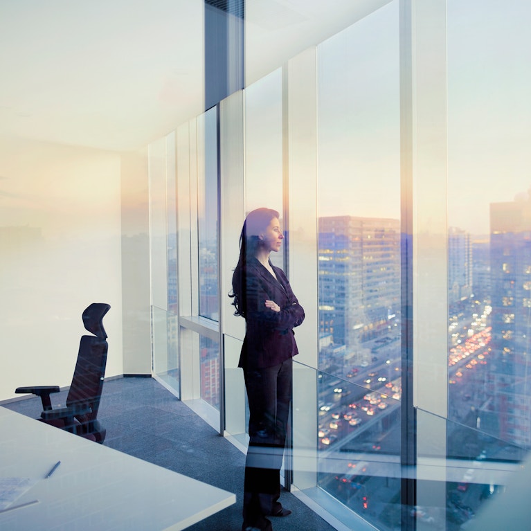 Businesswoman looking out window in meeting room