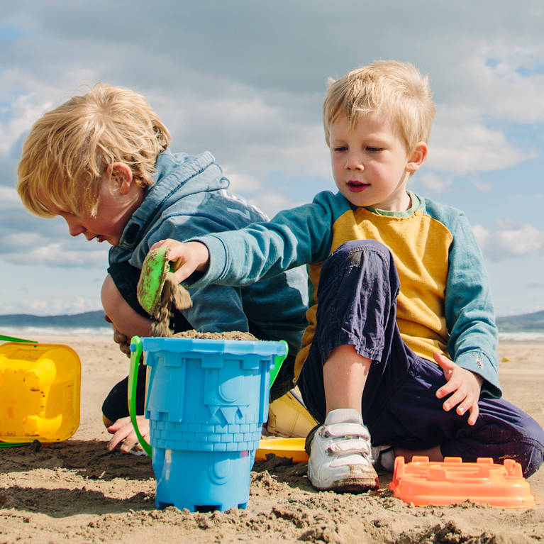 Boys making sandcastles on the beach